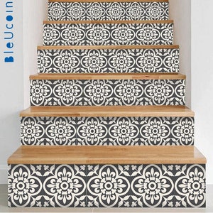 May include: Black and white patterned stair treads with a floral design. The stair treads are made of a self-adhesive vinyl material and are easy to apply.
