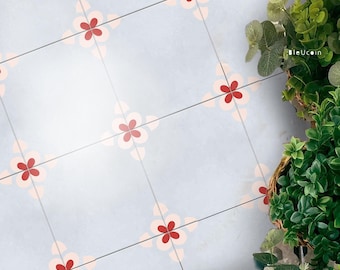 May include: Light blue tile with a repeating floral pattern in red and peach. The tiles are divided by dark gray lines. A basket of green plants is in the upper right corner. The text "bleUcoin" is visible.