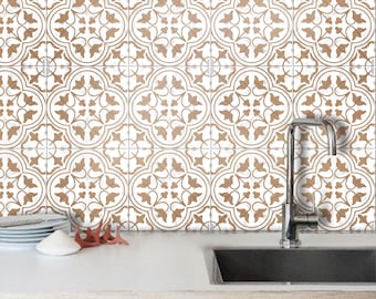 May include: A white kitchen backsplash with brown patterned tiles. The tiles have a geometric design with a floral motif. A stainless steel kitchen sink is below the backsplash.