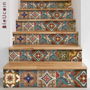 May include: A set of stair risers decorated with colorful square tiles featuring intricate floral, geometric, and scroll patterns in shades of blue, red, green, yellow, and brown. The tiles are arranged in a repeating sequence across the wooden steps.