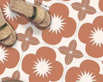 May include: A white floor with brown and orange floral tile pattern. A straw hat and a pair of brown sandals are on the floor.