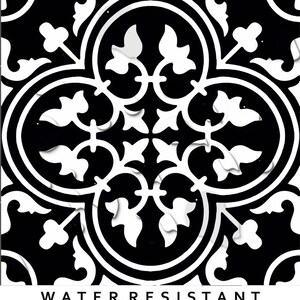 May include: A square tile featuring a high-contrast black and white pattern with symmetrical floral and quatrefoil motifs. The design includes interconnected curved lines and leaf-like shapes. The text WATER RESISTANT is printed in black below.