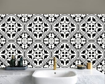 May include: Black and white patterned tile backsplash with a white porcelain sink and gold faucet in a modern bathroom.