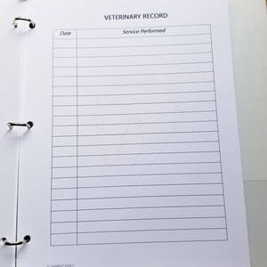 May include: A white veterinary record binder with the title "Veterinary Record" and columns for "Date" and "Service Performed".