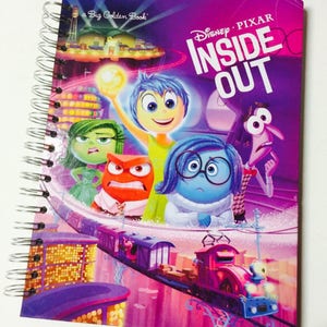 May include: Spiral-bound notebook featuring the Disney Pixar movie "Inside Out." The cover displays colorful illustrations of the characters Joy, Sadness, Anger, Disgust, and Fear, with the movie title in large white letters against a purple background.