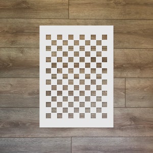 May include: White stencil with a checkered pattern. The stencil is made of a thin, flexible material and is designed for use with paint or other mediums.