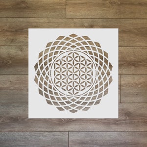 May include: White stencil of a geometric flower of life design. The design is a circle with multiple layers of overlapping geometric shapes.