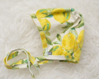 lemon print pilot hat by Little Lapsi. Baby hat with ties.