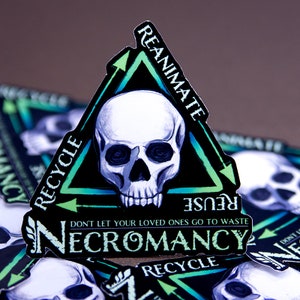 May include: A black and green sticker with a skull in the center and the words "REANIMATE", "RECYCLE", "REUSE", "DON'T LET YOUR LOVED ONES GO TO WASTE", and "NECROMANCY".