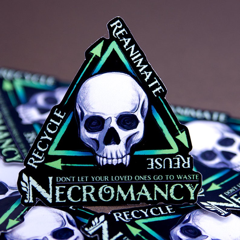May include: A black and green sticker with a skull in the center and the words "REANIMATE", "RECYCLE", "REUSE", "DON'T LET YOUR LOVED ONES GO TO WASTE", and "NECROMANCY".