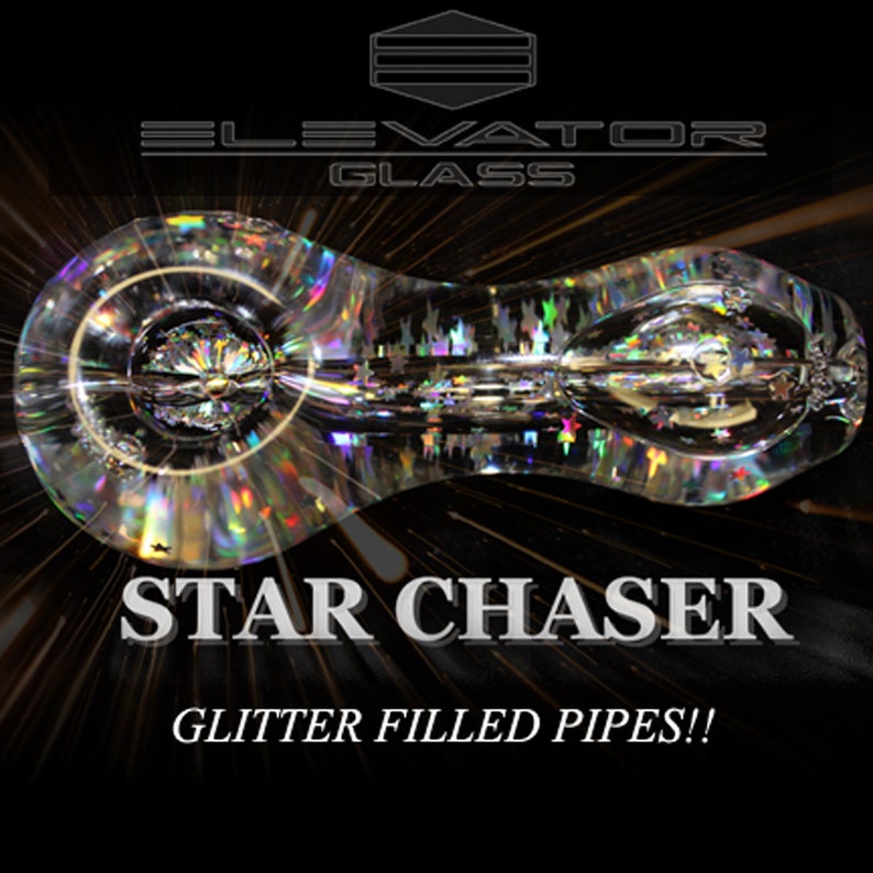 May include: A clear glass pipe with iridescent glitter embedded in the glass. The pipe is shaped like a teardrop and has a small bowl at one end. The text "STAR CHASER" and "GLITTER FILLED PIPES!!" is printed below the pipe.