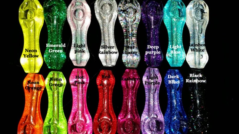 May include: A collection of 18 glass pipes with various glitter colors, including neon yellow, emerald green, light pink, silver rainbow, star chaser, deep purple, light blue, rainbow white, neon orange, neon green, hot pink, red, raspberry, light purple, dark blue, and black rainbow.