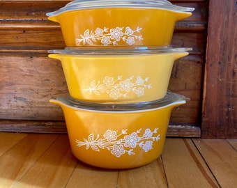 Set of Butterfly Gold Pyrex casseroles with lids