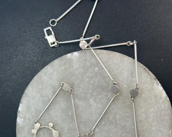 Penny necklace: A sculpted open and closed circle pendulum style chain necklace