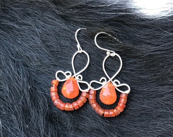 The Emma earring: hand formed sterling silver wire with a orange carnelian teardrop bead and a string of orange carnelian round beads