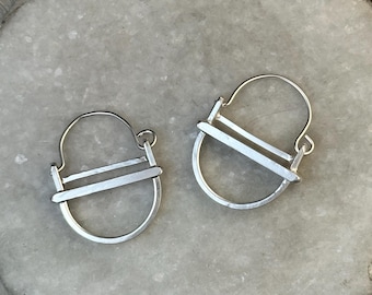 The small "kandy" earring is three layers of brushed silver structured and rounded