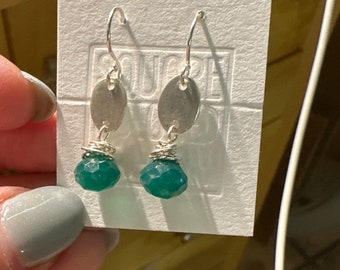 The "Josie" earring, handcut and refined silver oval shape, a green onyx onion shaped briolette bead and a sterling silver hook