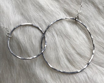 The 19" Lydia necklace is made of two sterling silver interlocking circles of contrasting size connected to a sliver chain