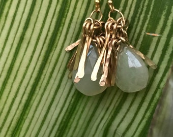 The "Gertrude" earring is a tassel made of hand forged 14k gold fill fringe topping white chalcedony briolette stone bead and earwires