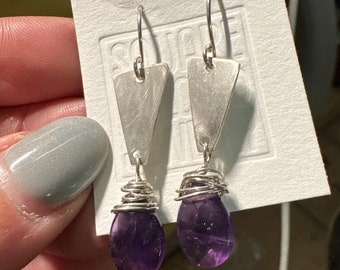 The "Josie" earring, handcut and refined silver triangle shape, a purple amethyst teardrop shaped rosecut bead and a sterling silver hook