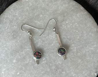 The “Dana” earring,  two Kyocera black opal cabochon (lab grown) stones set on a strip of sterling silver fringe
