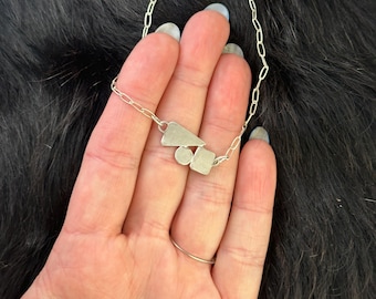 Geo necklace with a triangle, circle and rectangle focal point