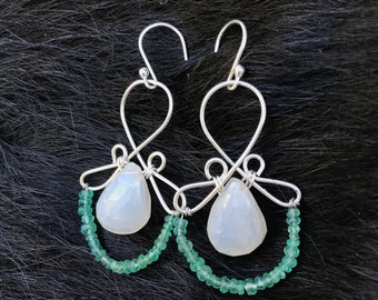 The Emma earring: hand formed sterling silver wire with a white chalcedony teardrop bead and a string of natural bright green emeralds