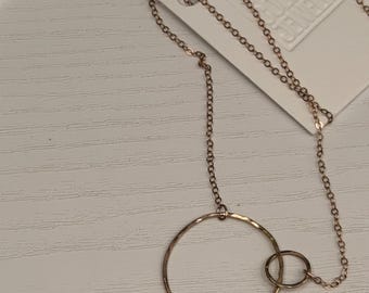 The Lydia necklace is two interlocking 14k rose gold circles of contrasting size with 14k rose gold filled chain