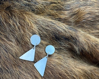 Maude earring a geometric shaped dangle earring circle and triangle post and nut ear attachment