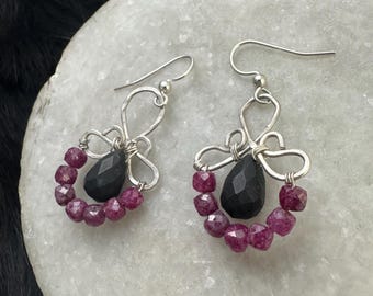 The Emma earring: hand formed sterling silver wire with a matte black onyx teardrop bead and a string of red ruby square beads