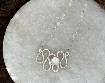 Marlee necklace a sterling silver necklace with mother of pearl stone set on a squiggle design