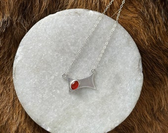 Ingrid necklace, an irregular square sterling silver metal shape with small orange carnelian stone