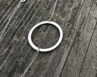 The circle necklace, made of fine sliver by hand on a 19 1/2 inch sterling silver chain