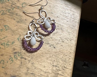 The Emma earring: hand formed sterling silver wire with a white jade  teardrop bead and a string of purple amethyst round beads