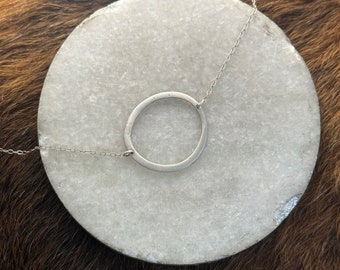 The circle necklace, hand formed fine silver circle connected to a 19 1/2 inch sterling silver chain