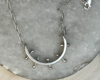 medium arc shape with kinetic balled bars extended through each side focal point necklace with lightweight paper clip chain Connie necklace
