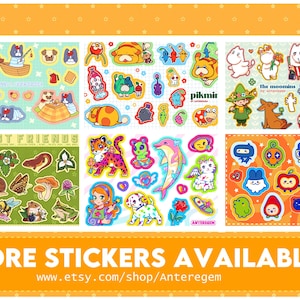 May include: A collection of colorful sticker sheets featuring various cartoon characters and designs. The stickers include animals, fantasy creatures, and characters from "The Moomins" and "Pikmir". The bottom banner reads "MORE STICKERS AVAILABLE!"