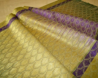 May include: A woven fabric with a gold and purple diamond pattern. The fabric has a subtle sheen and a soft texture.