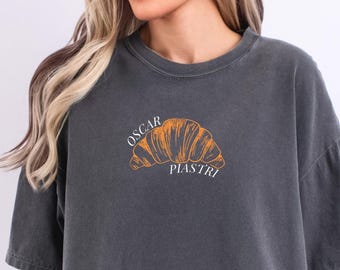 oscar piastri pastry/croissant mclaren f1 tee | pepper comfort colors tshirt | formula 1 racing inspired aesthetic modern f1 merch