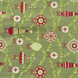 May include: A sage green fabric featuring a repeating pattern of red and white Christmas ornaments, including round baubles and elongated finial shapes, interspersed with delicate light green pine branch garlands and small red bows.