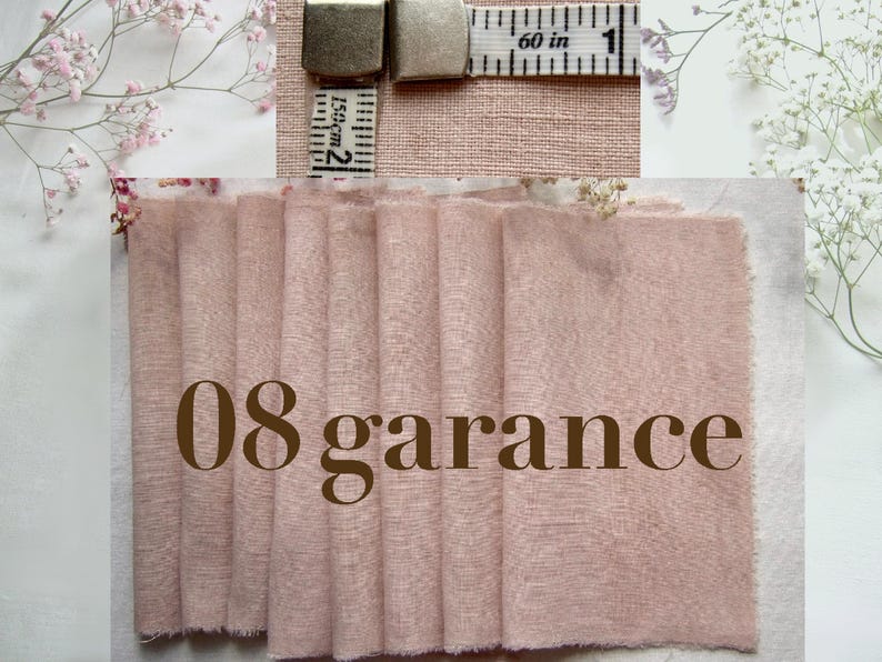 May include: A swatch of dusty pink fabric with a visible woven texture, featuring the text 08 garance in brown. A measuring tape is positioned at the top, showing a measurement of 1 inch or 2.5 centimeters across the width of the fabric sample.