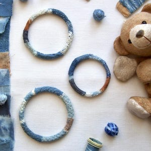 Textile bracelet made of hand stitched vintage linen fabric and hand dyed with organic indigo for a blue boro sashiko cord fiber art bangle