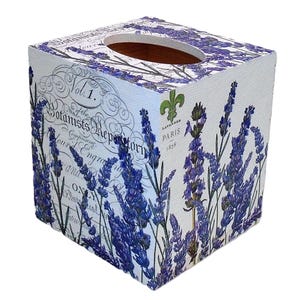 May include: A white tissue box with a floral lavender design. The box features blue lavender sprigs and text that reads "Vol. 1. Botanists Repertory" and "Lavender Paris 1878". The top has a circular opening for tissue dispensing.