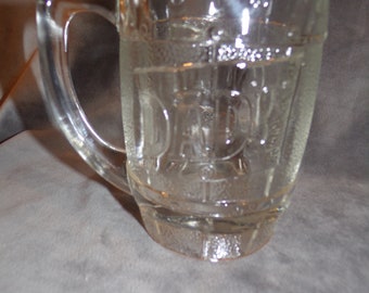 May include: A clear glass mug with a barrel design and the word "Daddy" embossed on the side.