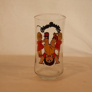 May include: A clear glass with a colorful illustration of three children playing. The illustration features a boy upside down with two girls holding his legs. The text "Cabbage Patch Kids" is printed on the glass.