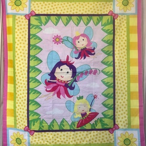 May include: A pink, yellow, and green fabric with a repeating pattern of stars, stripes, and flowers. Three fairies with wings are flying in a garden setting. The fairies are wearing pink, purple, and red dresses.