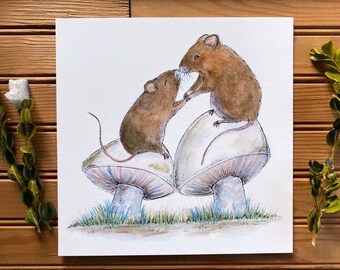 May include: Two brown mice are perched on top of white mushrooms with brown caps. The mice are facing each other and appear to be interacting. The mushrooms are drawn in watercolour on a white background.