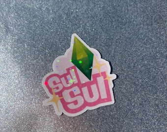 May include: A pink and white sticker with the text "sul sul" in a pink bubble font. A green diamond shape is above the text.