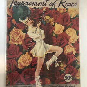 May include: A vintage program for the Tournament of Roses parade in Pasadena, California. The cover features a color illustration of a female drum majorette in a white uniform, holding a baton and standing in a field of red, yellow, and white roses. The text on the cover reads "Tournament of Roses", "67th Anniversary", "1956 Official Program", and "50¢".