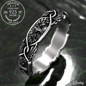 May include: A silver ring with a detailed tree of life design. The ring is made of sterling silver and is nickel free.